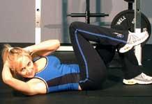 Curl up and bring your right elbow and shoulder across your body while bring your left knee in toward your left shoulder at the same