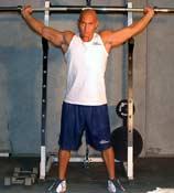 Barbell Tips: Place the bar overhead using a side snatch grip with the arms locked out.