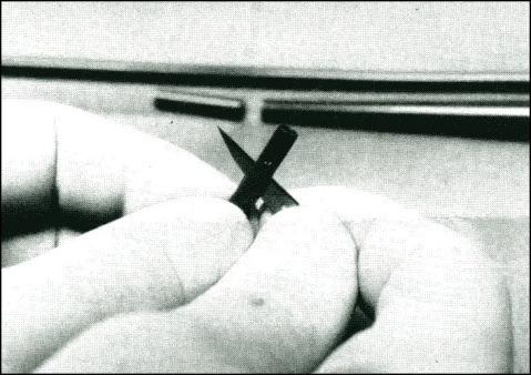 12. Use the 18-gauge needle as a suture passer, to pass the free end of the suture through the pointed trimmed end of the Pezzar catheter, for 2-4 passes.