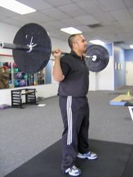 Squat How To: Place the bar as high on your neck as comfortable.