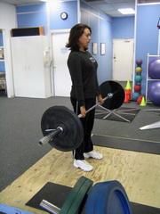Romanian Deadlift How To: Take a medium grip (about shoulder width) and commence in a standing position.