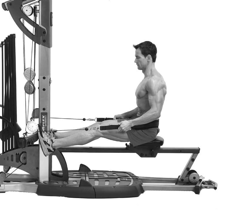 position the leg press belt around your hips. Slide forward to the pulleys and place your feet through the right and left openings under the rod cables.