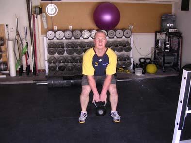 It is important when performing kettlebell swings to drive through with your hips (i.e., don't just stand up) and to swing the kettlebell forward and up to shoulder height and back down in one uninterrupted and controlled motion.