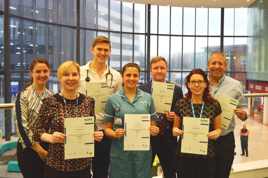 Champions pick up new national qualification THE first group of workplace health champions to complete a nationally recognised course in public health received their certificates.