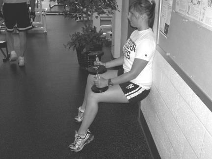 With dumbbells placed on your knees rise up on your toes, squeezing the calf muscles.