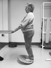 CHAPTER 5 Exercise and Physical Activity for Older Adults 83 FIGURE 5-14 Left hip flexor stretch in a Thomas test position. FIGURE 5-15 Heel cord stretch on Rocker Board.