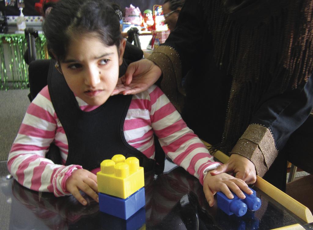 Clockwise from top left: Tahreem works on a puzzle; a variety of tangible symbols hang on the Velcro board in the classroom; Tahreem locates the tangible symbol for gym among a selection of symbols