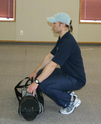 Exercise - Golf bag deadlifts Description: Place the golf bag lying in front