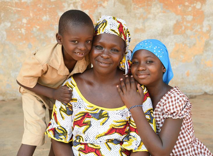 Sylla sits in front of her house in Côte d Ivoire with her youngest child, Ladji, 5, and her oldest child, Djona, 10.