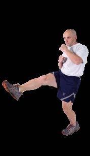 Front Kick Start in a fighting stance, with knees slightly bent, abs tight and hands at chin level.