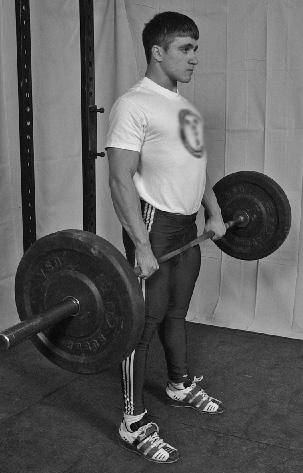 The bar is gripped with both hands outside the legs, and pulled with one continuous uninterrupted movement until the lifter is standing erect with knees and hips fully extended, the chest up and