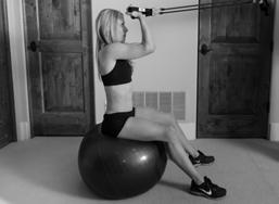 ) Sit straight up onto of the exercise ball, back upright holding the exercise band in both hands at the same level as the top of your