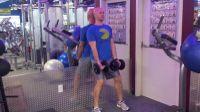 Perform a lateral raise, lifting the dumbbells up and out to the side.