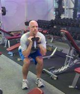 hip-width apart. Hold the dumbbell at chest height.