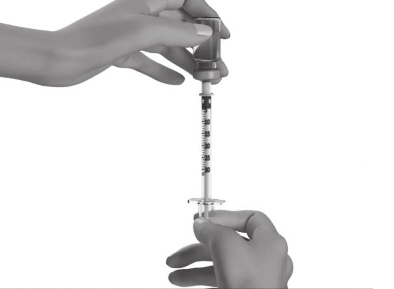 Hold the STRENSIQ vial firmly on a flat surface, then push the needle through the rubber stopper of the STRENSIQ vial.