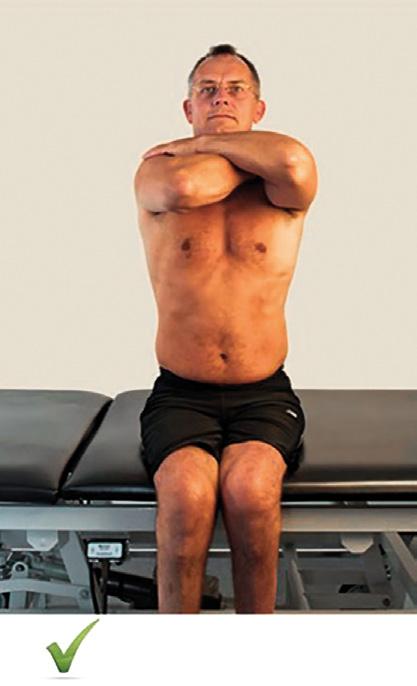 feet unsupported. The athlete crosses the arms in front of his chest, to prevent support for sitting balance from the arms.