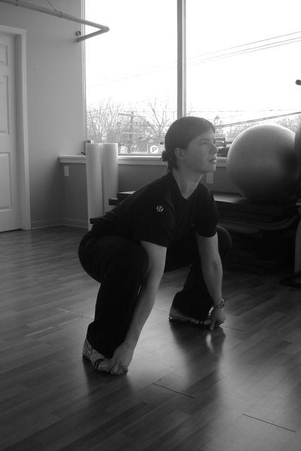 Pull yourself down into a deep squat position keeping the chest up and elbows inside knees.