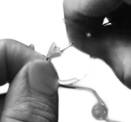 Clean Ear tube & tip Thread the cleaning wire through the tube, starting at the triangle end, until it comes out at the