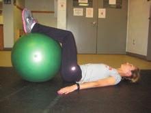 on floor with hips and knees bent to 90 degrees over a physioball; draw in