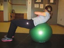 Supine Bridging on Physioball Lie facing upward on floor with knees straight, feet resting on physioball, arms