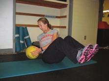 Seated on Physioball with feet planted; hold medicine ball