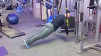 Suspended Pushup Keep the abs braced and body in a straight line from toes to shoulders.