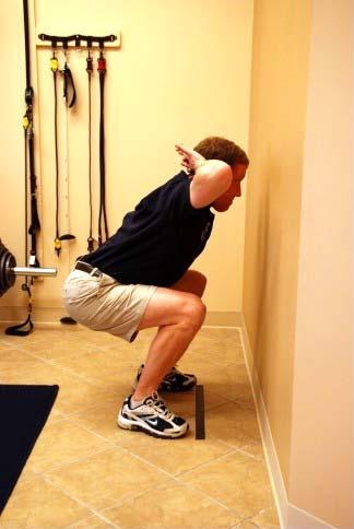 8. Squats a. Test Place a piece of tape on the floor one-foot length (your foot) from a wall. Stand with your feet shoulder width apart with your toes touching the tape and your feet pointing forward.