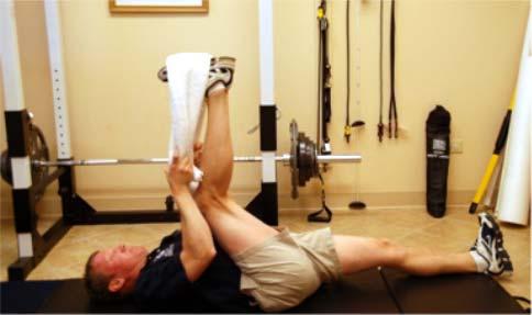 Execution: Bend one knee up to your chest and wrap a towel over the bottom of your foot. Straighten your leg until you feel a stretch in the back of your leg.