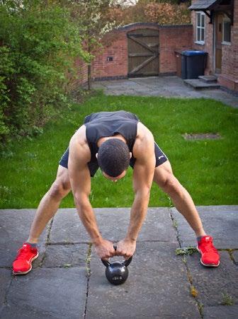 Place a kettle bell on the ground in front of you and grab onto it with both hands.