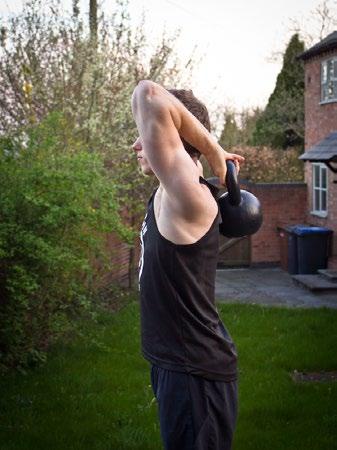 Squeeze your triceps muscles to lift the kettle bell overhead and extend your arm - avoid locking out the elbow at the top.