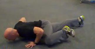 into a pushup, bringing one knee to the side.