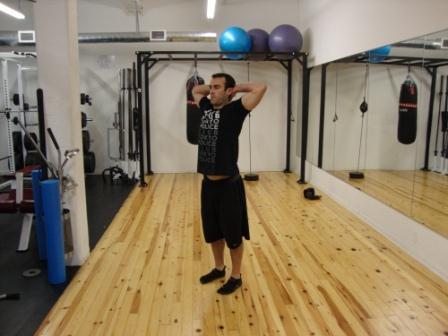 Workout F Alternating Prisoner Reverse Lunge Stand with your feet shoulder-width apart and hands clasped behind your head.