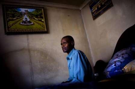 The Human Facts Johannes Khumalo sits on his bed inside his home in Wadela, a small, poor, mining community.