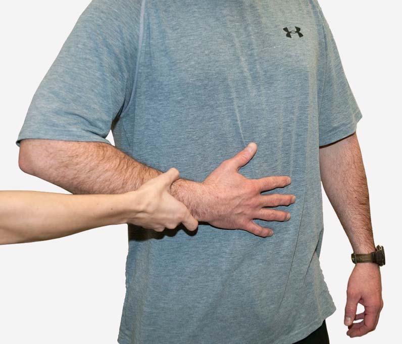 Elbow anterior to midline Examiner