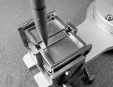 Setting the Adjustable Incisal Guide Table After the anterior denture teeth are positioned, the adjustable guide table may be set. Fig. 28 Release the locking mechanisms on the articulator.