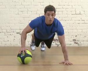 Begin in a pushup position with one hand on a med ball.. Complete push-up sets for each arm.