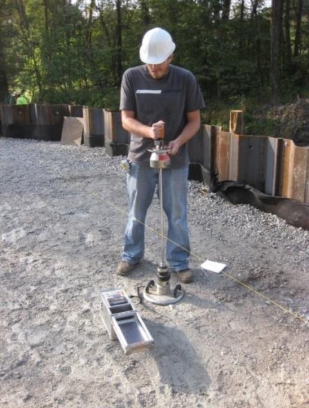 a.) Testing on abutment backfill at base of spread footing b.