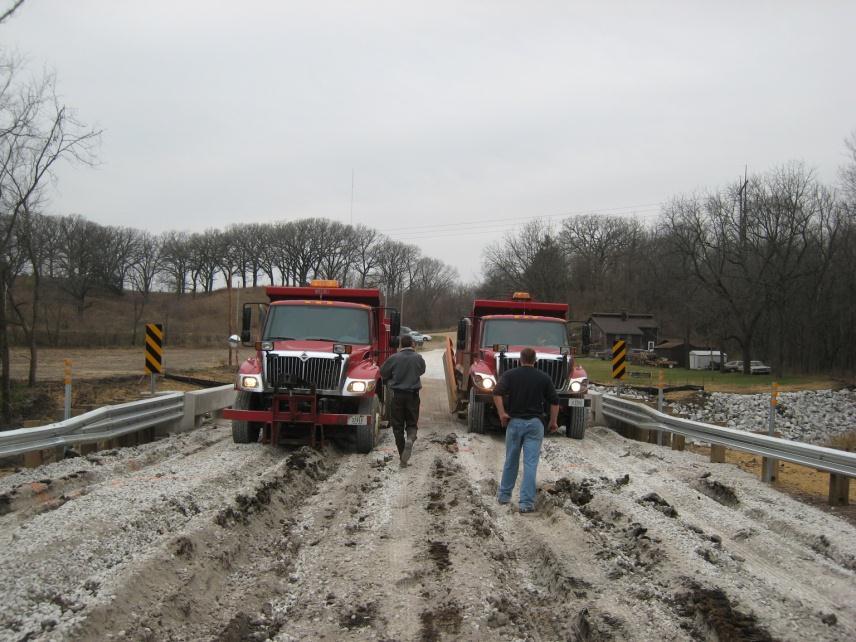 During the live load testing, severe rutting in the east approach occurred (see Figure 5-106) and grading of the roadway was necessary after the testing; proper compaction of approach fill would have