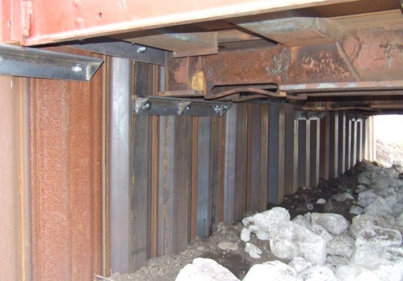 ) Stiffened angles bolted to piling supporting