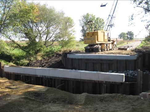 Abutment Cap: The abutment cap consisted of a precast element designed by BHC. The 33 ft long cap consists of a W12x65 section capped with reinforced concrete as shown previously in Figure 5-6a.
