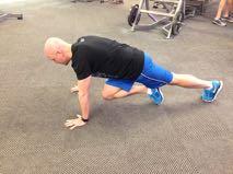 Perform an X-Body Mountain Climber by bringing one knee towards the opposite elbow, keeping your body in a straight line. Repeat for the other side. That s one rep repeat as necessary.