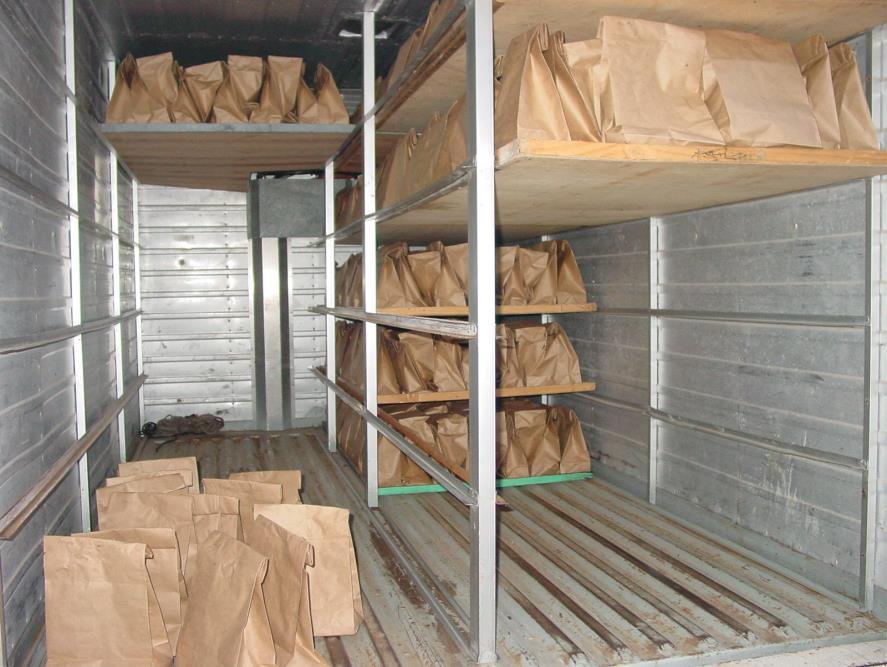 Figure 8.7 Paper bags are stacked on trays in the back of a small truck. Bags may be inverted to save space. Bags need to be torn open to allow flies to escape the bag at release sites.