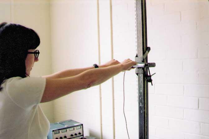A static pushing or pulling force is exerted on a cylindrical bar placed at shoulder height