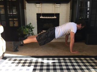 Lower yourself down to perform a push-up.