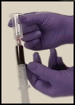 The syringe is attached to the luer adapter on the outside portion of the transfer device. The evacuated tube is pushed on to the multiple sample needle inside of the transfer device.