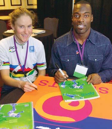 World Cup Mountain Bike Champion Alison Dunlap and New Orleans Saints wide receiver Willie Jackson sign copies of a book that promotes a healthy lifestyle as an alternative to tobacco use for young