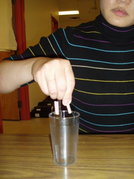 cup. Using your weaker hand, take each peg off the cup and place on