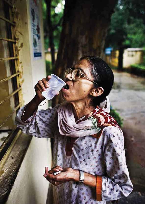 A TB patient takes her medication at Kingsway Chest Centre in north Delhi, India.