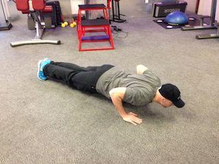 Hands are slightly wider than shoulder width apart (normal pushup width). Slowly lower yourself down until you are 2 inches off the ground.