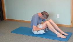 Knees to chest and grasp the right knee & shin as shown.